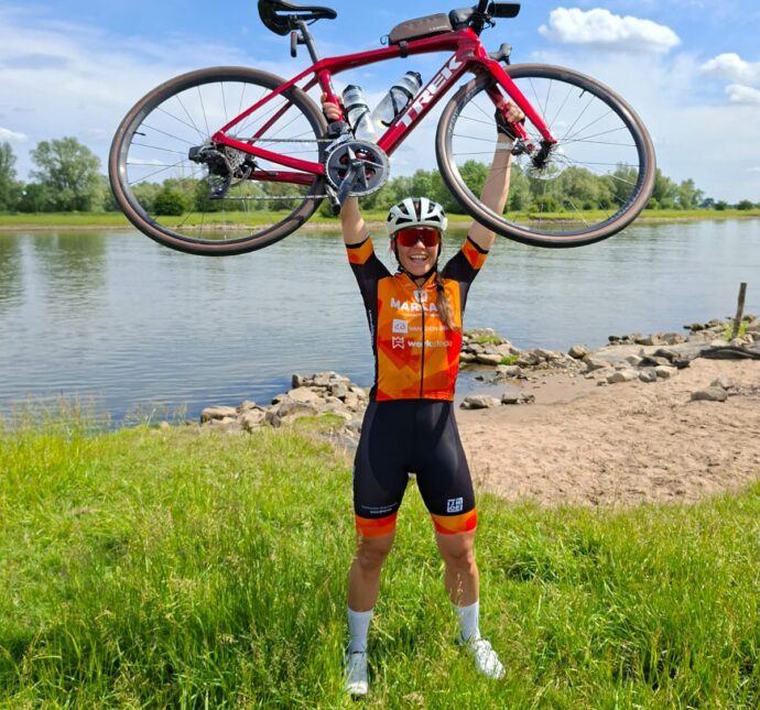 Anne-Wil met haar fiets boven het hoofd